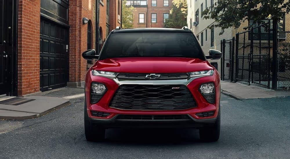 A red 2023 Chevy Trailblazer RS is shown from the front parked on a city street.