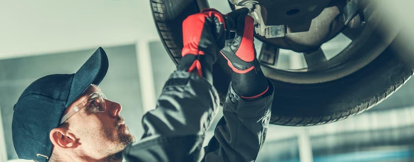 A mechanic is shown working on a vehicle at a used Chevy dealer in Nazareth.