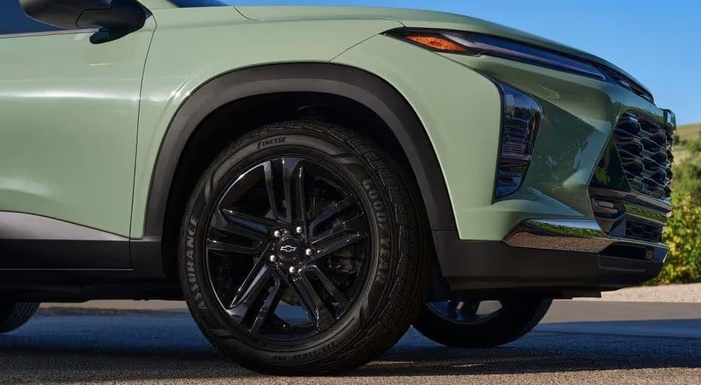 A close up shows the front end of a green 2024 Chevy Trax.