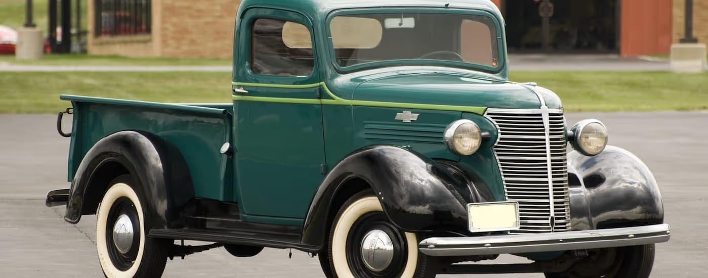 A green 1938 Chevy half ton pickup truck is parked in front of a brick building near Bethlehem, PA.