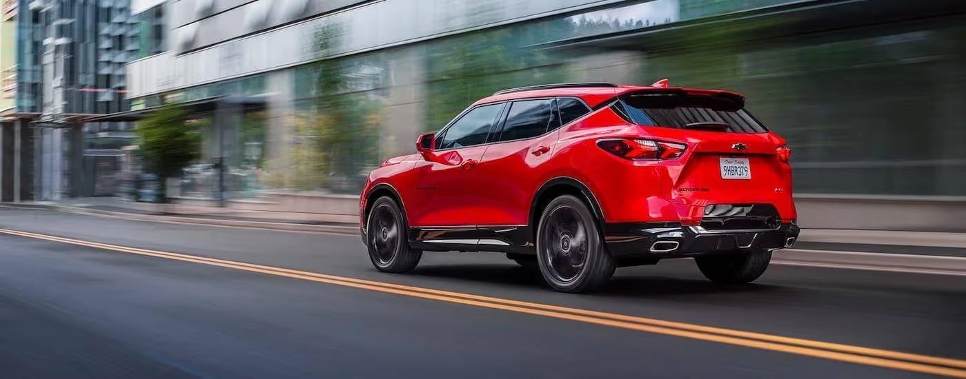 A red 2020 Chevy Blazer races down a city street after leaving a Chevy Dealership near Bethlehem PA