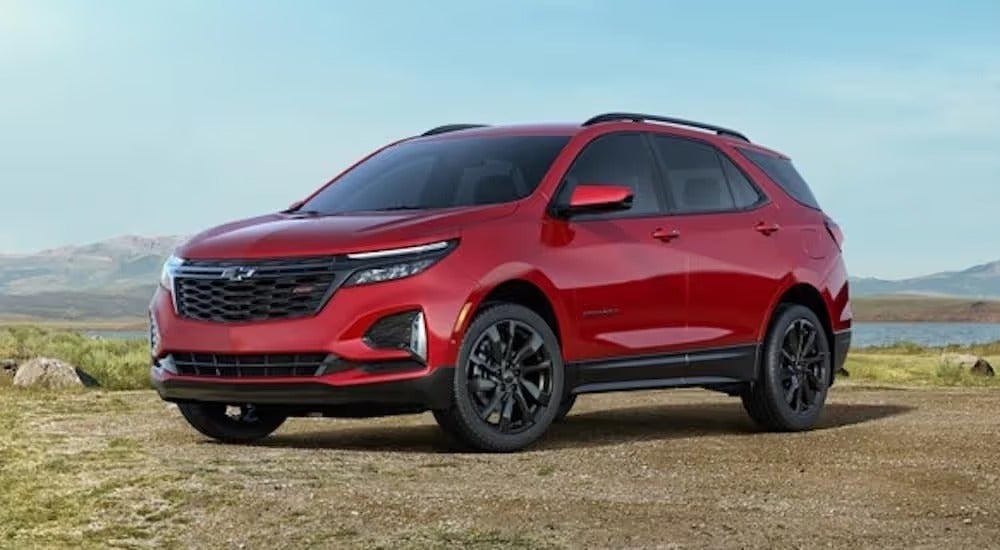 A red 2022 Chevy Equinox RS is shown from the front at an angle after leaving a dealer that has a Chevy Equinox for sale.